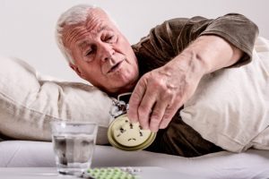 Man in Bed Looking at the Clock