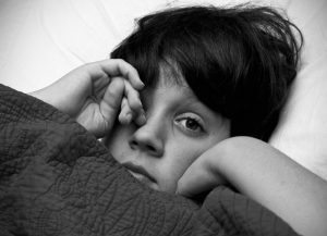 Boy Suffering From Poor Quality Sleep